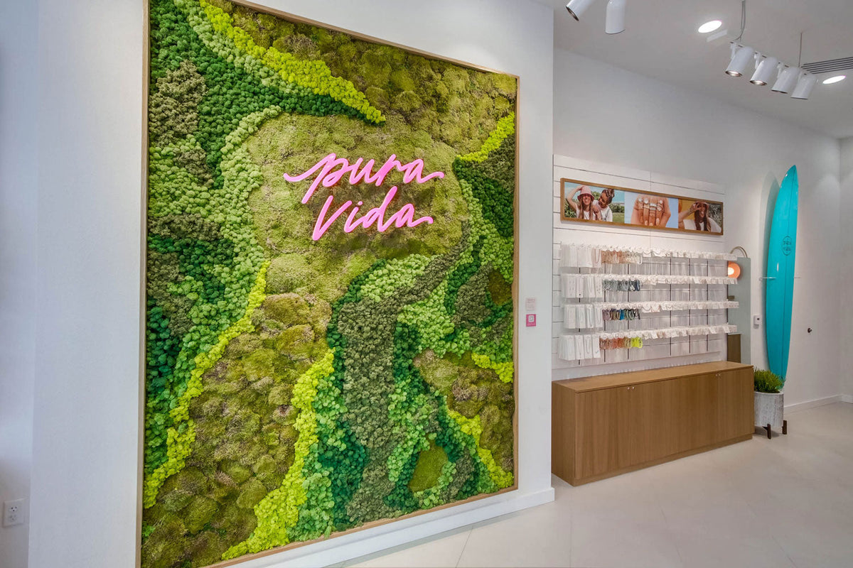 Pura Vida retail store moss wall with LED Pura Vida sign